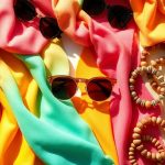 Woman wearing stylish scarf and sunglasses.